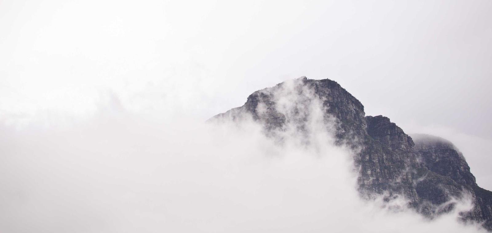 Majestic Himalayan mountain peak rising above low clouds